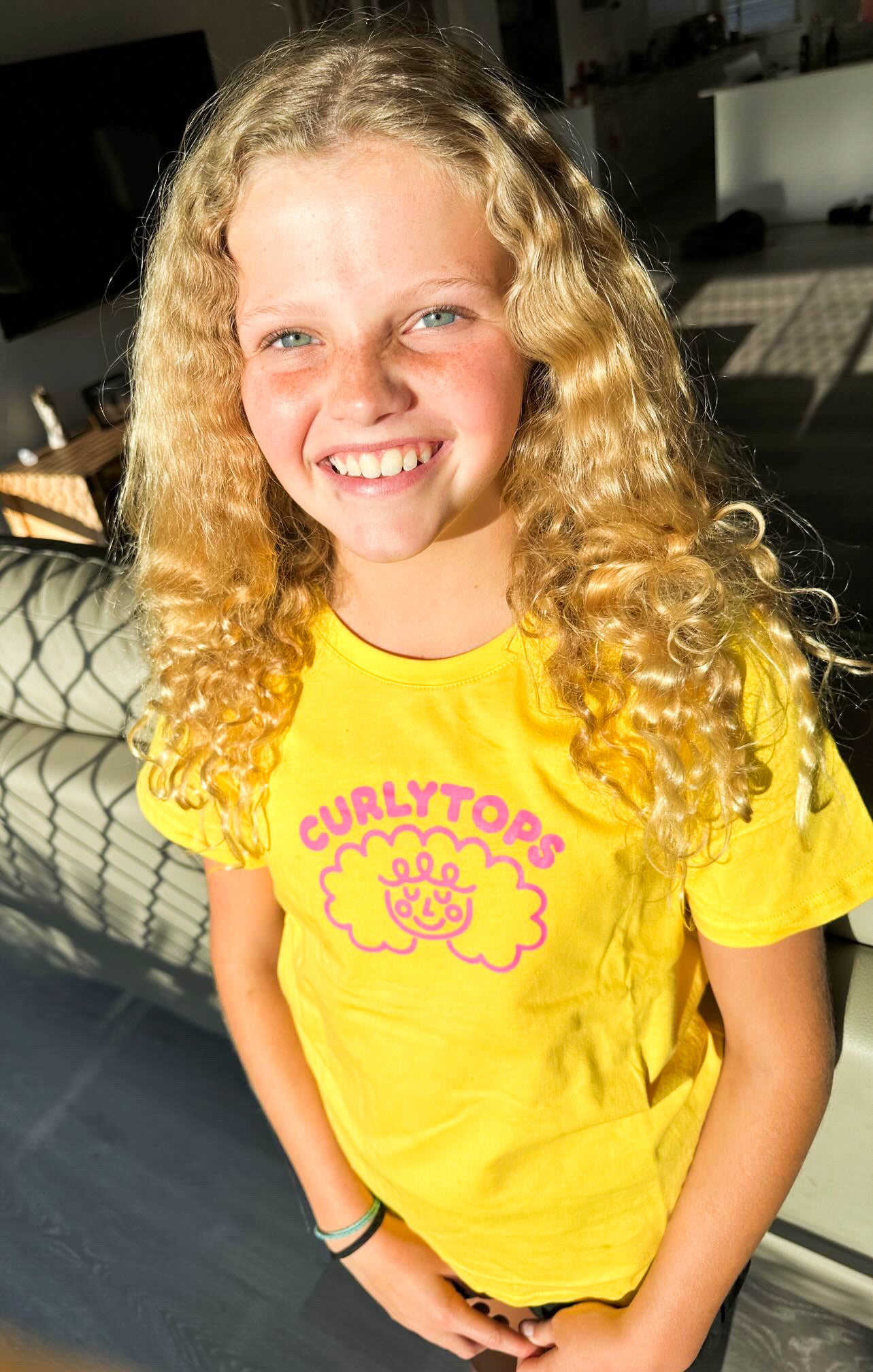 Josie Watts wearing Curlytops yellow t-shirt
